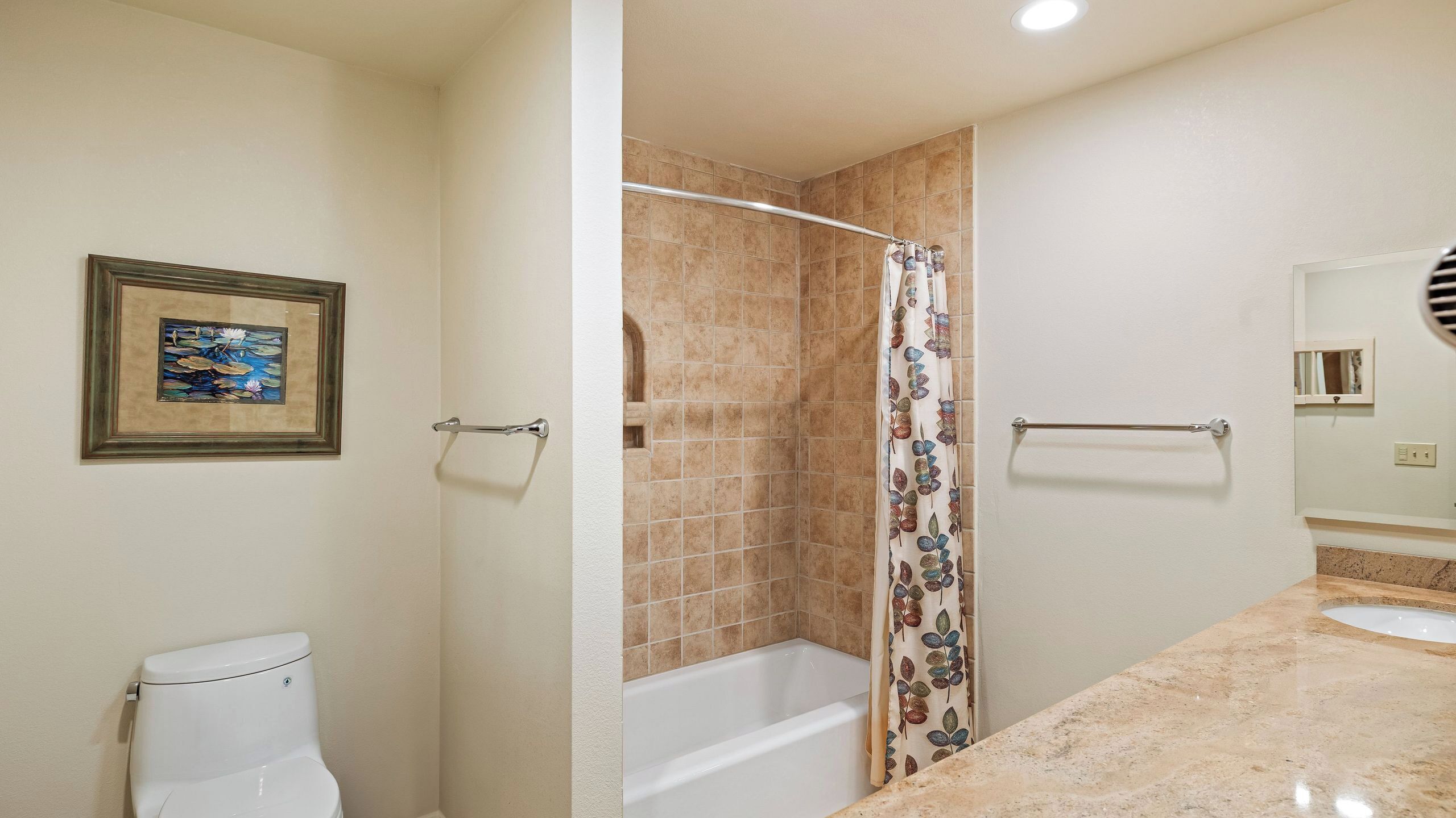A bathroom with a toilet, shower, bathtub, and a mirror.