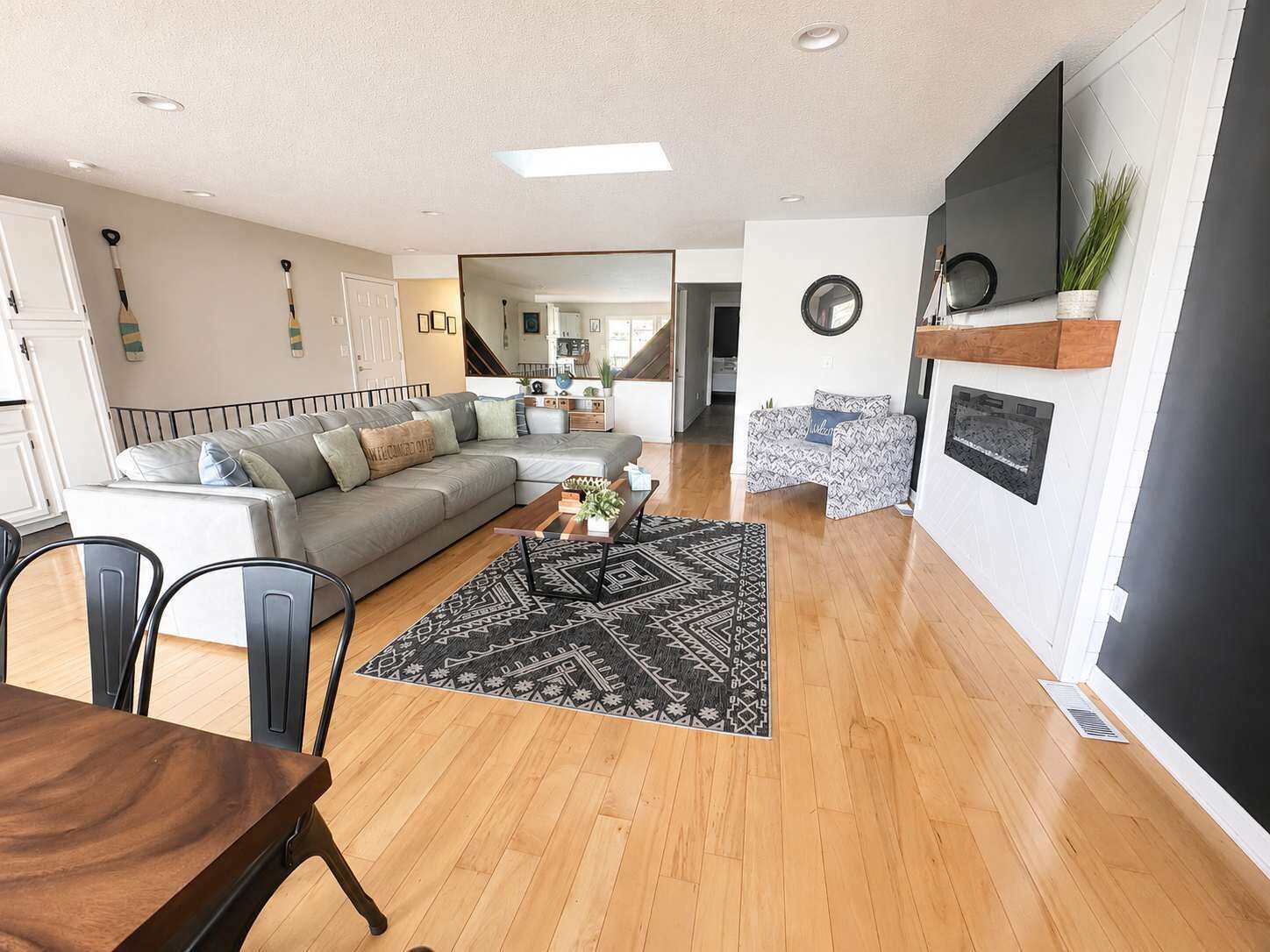 A modern living room with a sofa, coffee table, and dining area.