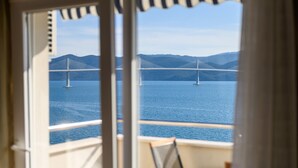 A view of a bridge over water with mountains in the background.