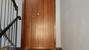 A wooden door with a brass handle and a keyhole, a metal handrail, and a tiled floor. - SE069 - Senigallia, large four-room apartment convenient to services (Senigallia)