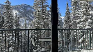 A balcony with a view of snow-covered trees and mountains. - Snowbird's PREMIER Ski-in Ski-out Suite @ Iron Blosam Lodge (Snowbird)