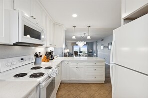 Fridge, microwave, oven, stovetop - Sunshine & Seashells | 2BR Oceanfront Haven w/ Private Balcony & Heated Pool 🏖️ (Cape Canaveral)