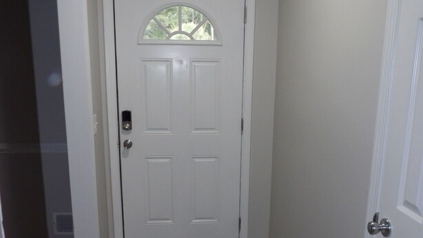 A hallway with a white door, wooden flooring, and white walls. - CLOSE TO FT JACKSON, WILLIAMS-BRICE STADIUM, VA HOSP, FAMILY FRIENDLY. SLEEPS 10 (Columbia)