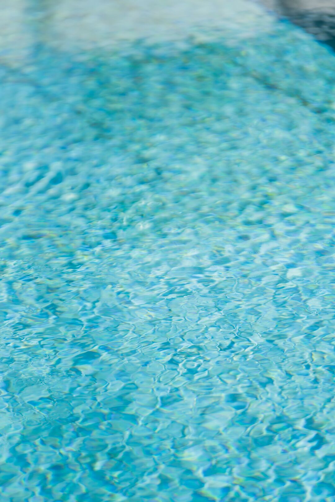 A close-up of clear blue pool water.