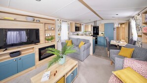 A modern RV interior with a living area, kitchen, and dining space. - Platinum 3 Pet Friendly (Clunderwen, Nr Narberth)