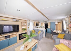 A modern RV interior with a living area, kitchen, and dining space. - Platinum 3 Pet Friendly (Clunderwen, Nr Narberth)