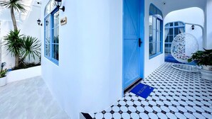A modern building with a blue door, a welcome mat, and a patterned floor. - Serena Villa, Da Nang city, Vietnam, 3 bedrooms, near the beach (Đà Nẵng)