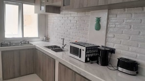 Enjoy cooking in this well-equipped kitchen with a microwave, coffee maker, and toaster.