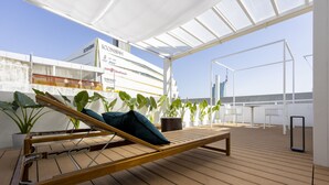 A wooden deck with a hammock and potted plants, overlooking a large cruise ship. - The Lair Bangkok (Bangkok)