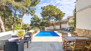 A pool area with lounge chairs and a dining table. - El Rinconcito by Interhome (Moraira)