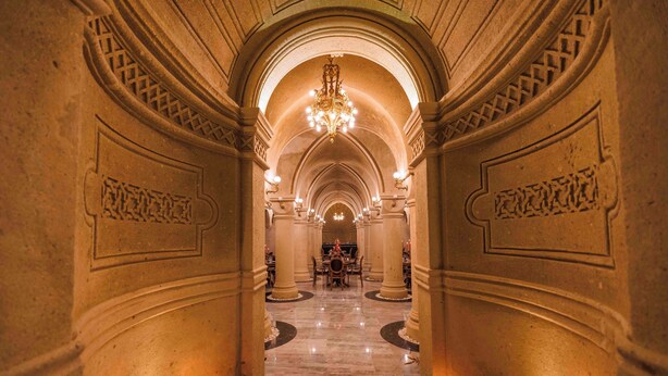 A grand hallway with a chandelier, marble floors, and candle-lit tables. - Signature Cave Cappadocia, Trademark Collection by Wyndham (Ürgüp)