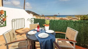 A table set for two with a view of the beach and ocean. - Apartment Baldri by Interhome (Tossa de Mar)