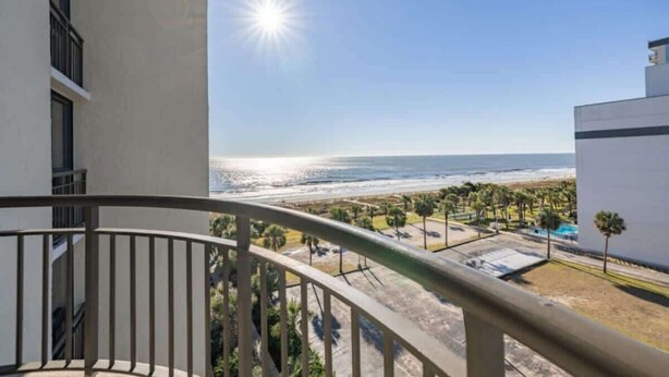 A balcony with a view of the beach and ocean. - King Suite, Kitchen, New HVAC, Ocean Views, Walk to Attractions & Restaurants (Myrtle Beach)