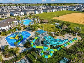A residential area with a water park featuring slides and a pool.