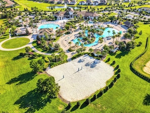 A golf course with a large swimming pool, multiple buildings, and well-maintained lawns.