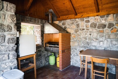 Traditional old house in a peacefull small village, surrounded by green forests.