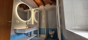 Een douche, een haardroger, een bidet, handdoeken