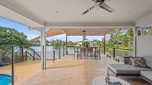 A spacious outdoor patio with a pool, a dining area, and a sofa. - Serene Lakefront Water side Villa with Private Pool  (Westlake)