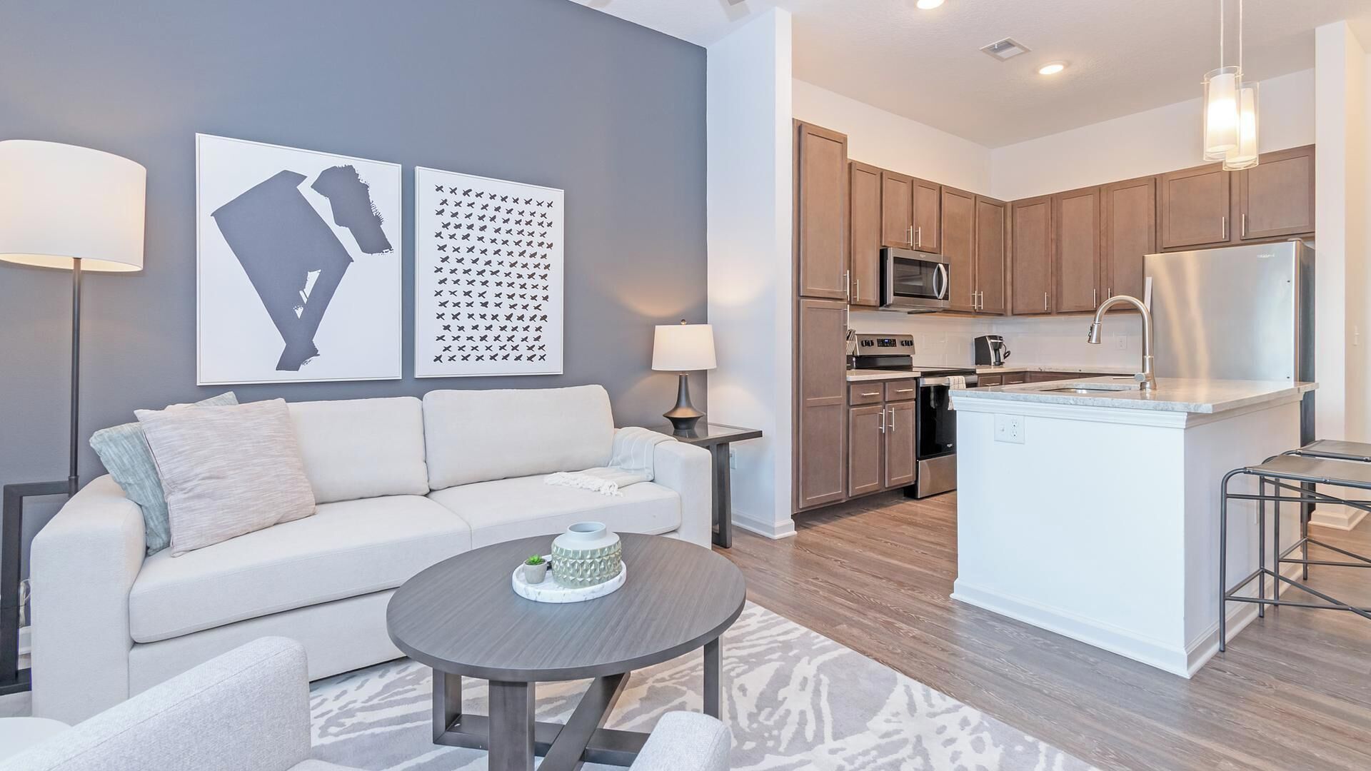 A modern apartment with a living room, kitchen, and dining area.