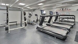 A gym with treadmills, a weight bench, and cardio machines. - BaseLoj - Pool, Firepit, Bike to Mountain! (Killington)