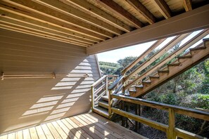 Step up to a scenic view from the deck with a staircase leading to an upper level.