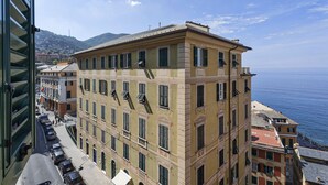 A multi-story building with a classic architectural style, featuring a balcony on the upper floor.