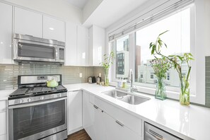 Design Condo | Private kitchen | Full-size fridge, microwave, oven, dishwasher - The Iris DT Condo with AC in Mission (Calgary)