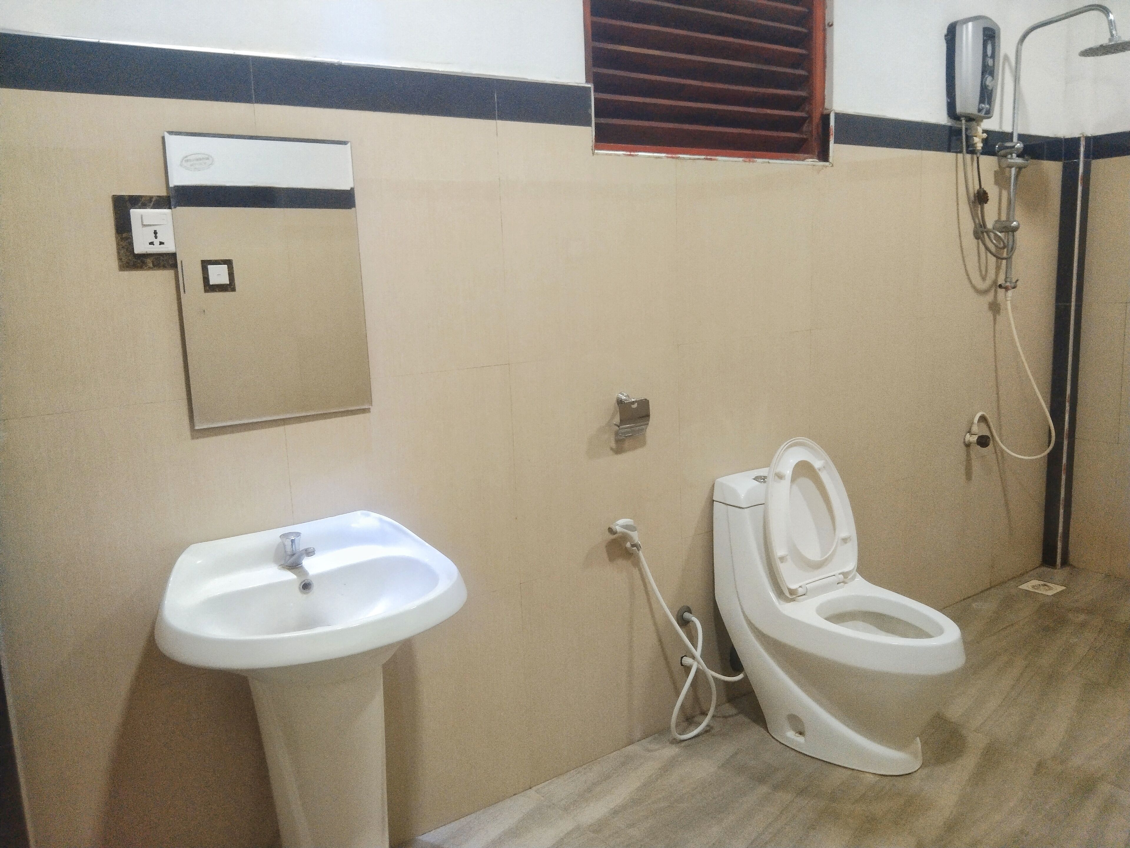 A bathroom with a sink, toilet, and shower.