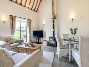 A cozy living room with a fireplace, a television, and comfortable seating.