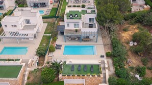 A modern residential complex with multiple swimming pools, outdoor seating areas, and well-maintained gardens. - V196| Villa Brisas - Four Bedroom Villa, Sleeps 8 (Torre Soli Nou)