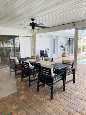 Enjoy dining al fresco on this outdoor patio with a table and comfortable seating.