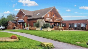 A wooden building with a reception area, a bar, and a sign for 'Crazy Horse Saloon.' - 2 bedroom accommodation in Felton, near Amble (Felton, near Amble)