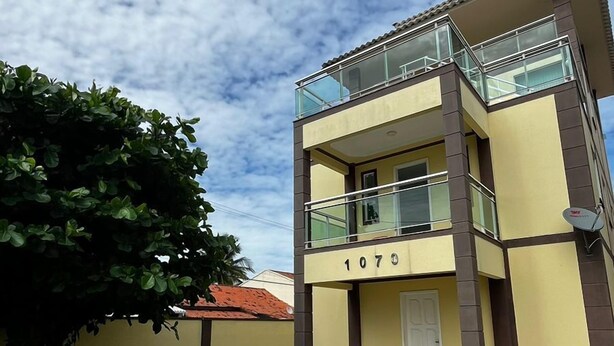 A two-story building with a balcony, a door, and the number 1070.