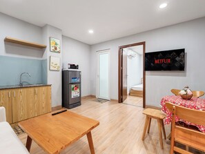 A compact living space with a kitchenette, a dining area, and a bedroom. - YOUR HOME - 1BR Apartment 60m² City View (Ho Chi Minh City)