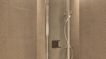 A modern bathroom with a glass-enclosed shower, a white toilet, and a wall-mounted towel rack.