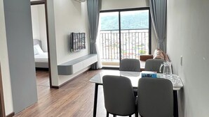 A modern dining area with a table and chairs, a built-in bench, and a view of the outdoors.
