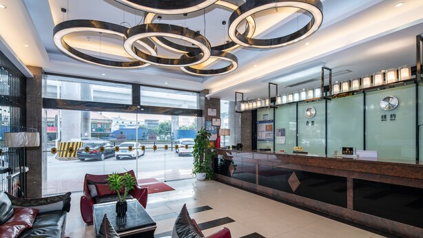 A modern lobby with leather seating, a reception desk, and a large window overlooking the street. - Baiyun Airport Grand Hyaat Airport Hotel - 24-hour Free Shuttle Bus (Guangzhou)