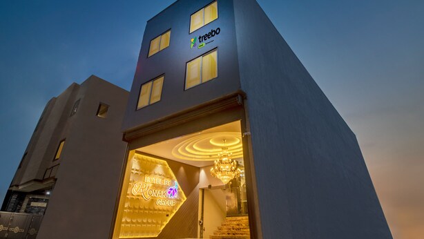 A hotel with a modern design, featuring a prominent logo and a well-lit entrance. - Treebo Taj Dream Agra (Agra)