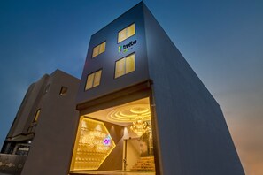 A hotel with a modern design, featuring a prominent logo and a well-lit entrance. - Treebo Taj Dream Agra (Agra)