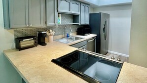 A modern kitchen with a built-in stove, a microwave, a refrigerator, and a sink. - ++PRIME LOCATION++ Cozy Condo in Tucson Catalina Foothills Area (Tucson)