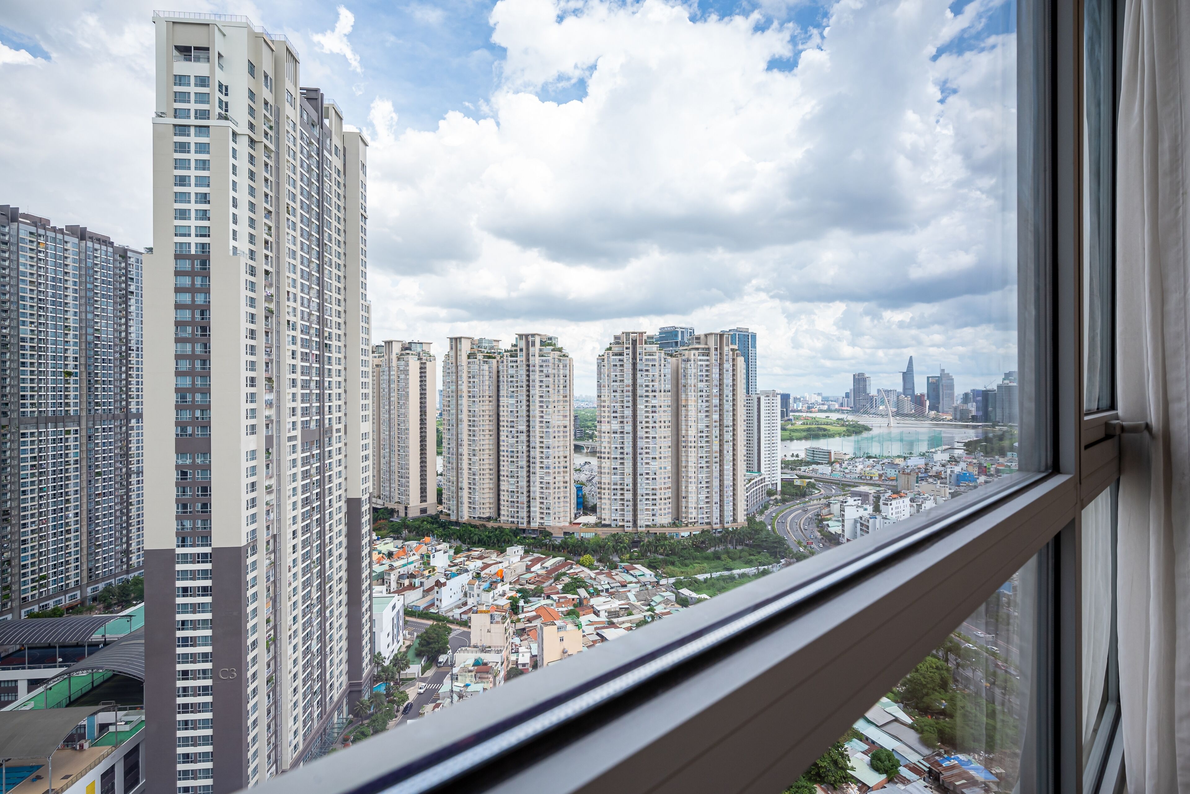A high-rise building with multiple floors and a view of a cityscape through a window.