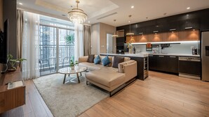 A modern apartment with a living room, kitchen, and balcony. - The Celavie Serviced Apartment Landmark (Ho Chi Minh City)