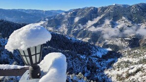 A snow-covered mountain landscape with a snow-laden street lamp in the foreground. - The Getaway BNB (Shimla)