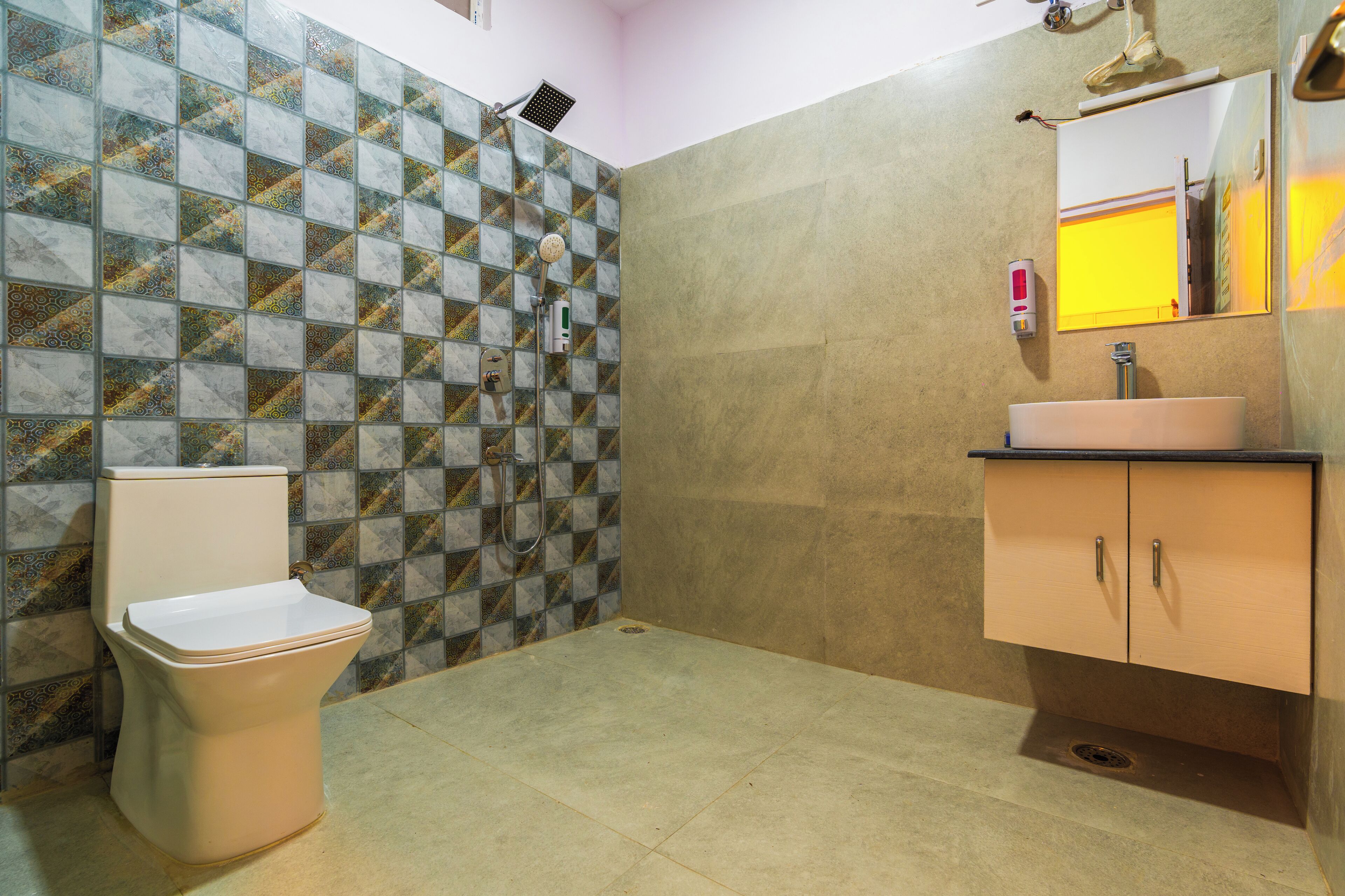 A bathroom with a toilet, sink, and shower.