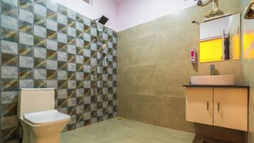 Une salle de bain avec des toilettes, un lavabo et une douche.