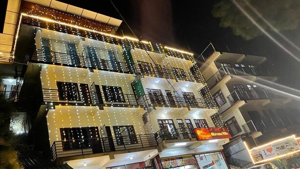 A multi-story building with a restaurant on the ground floor, a banquet hall, and a sign that says "I love Shikla." - Heavens Mahasu Villa By GRB (Shimla)