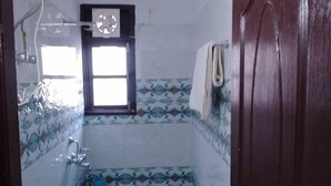 A small bathroom with a toilet, sink, and a window. - Heavens Mahasu Villa By GRB (Shimla)
