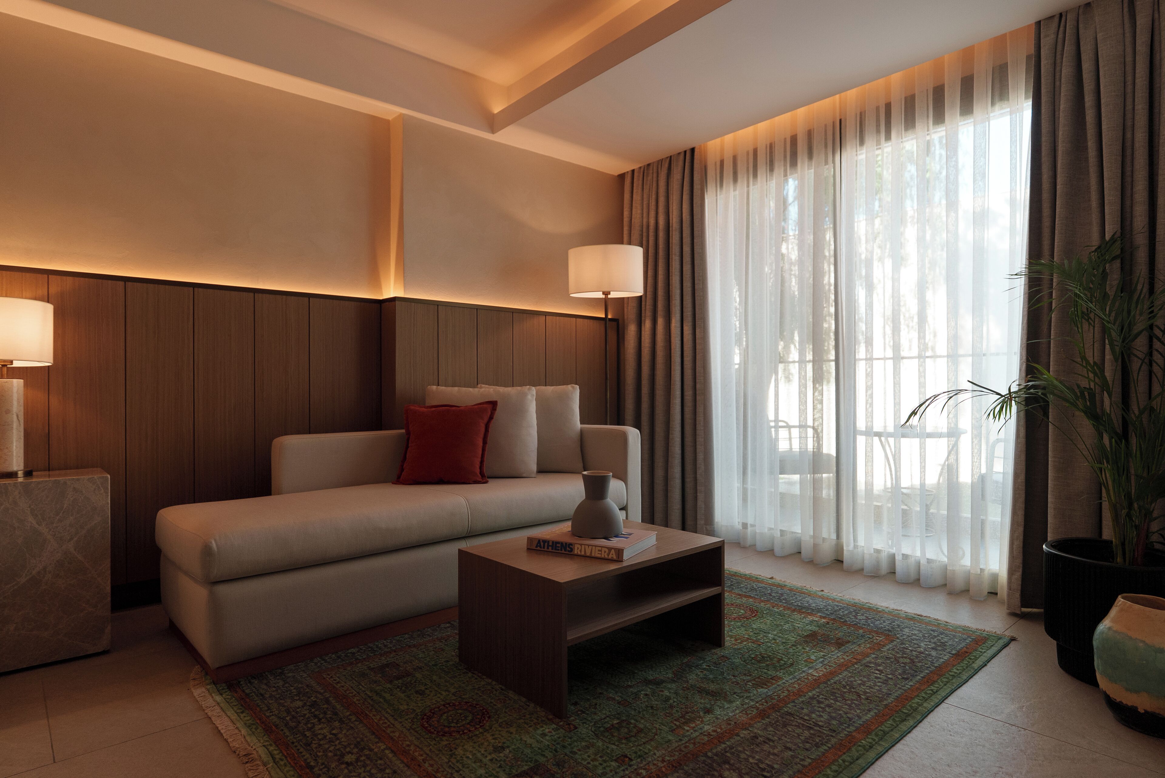 A modern living room with a sofa, a coffee table, and a lamp.