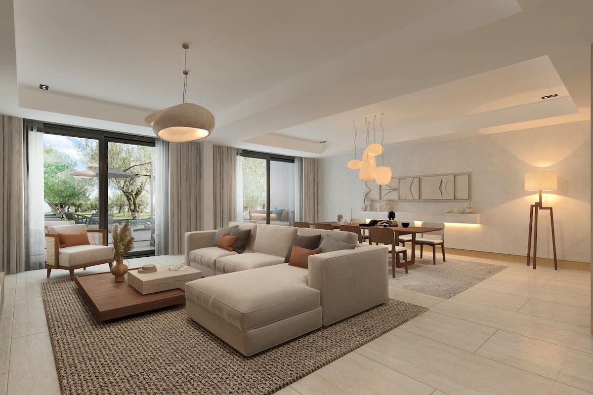 A modern living room with a sofa, coffee table, and dining area.