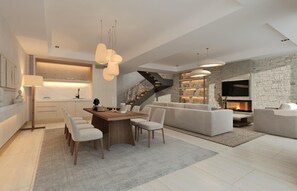 A modern living room with a fireplace, a dining area with a wooden table and chairs, and a staircase leading to an upper level.